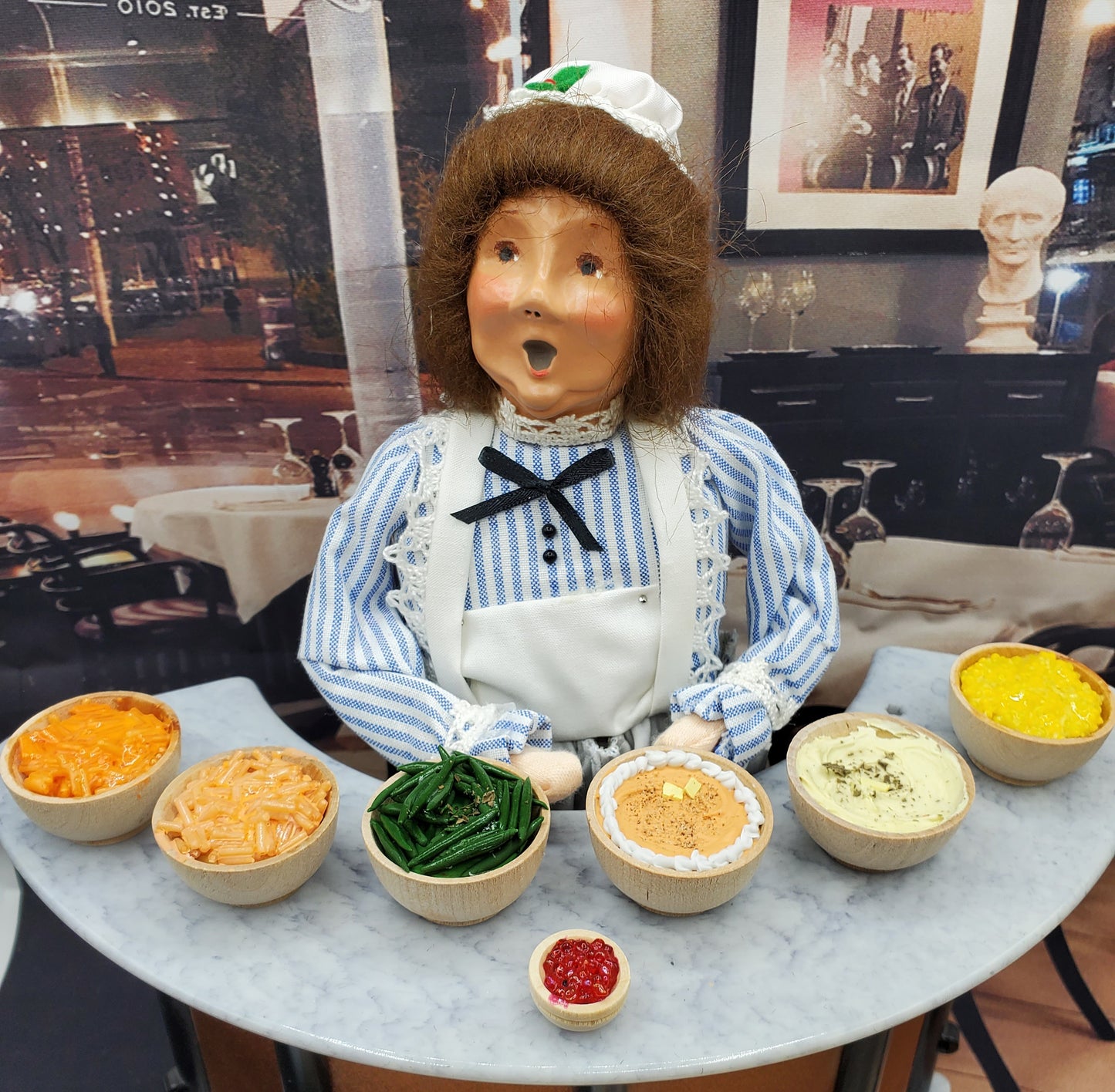 Chef Gina's Mini Food 1:6 scale creamed corn and assorted sides displayed on a marble table with a doll figure