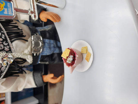 Cup of Chili with Crackers For Dolls by Chef Gina's Mini Food displayed on a white plate with a doll in the background