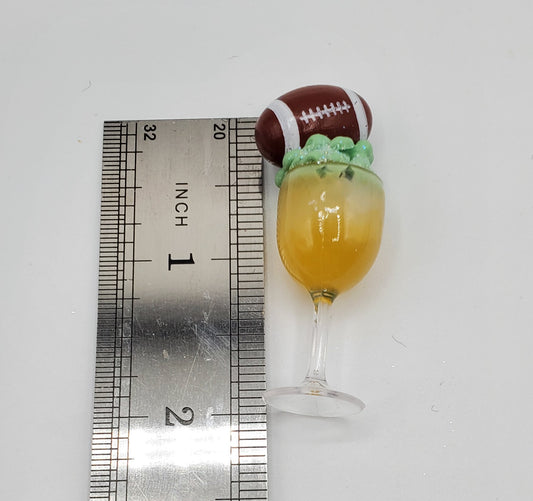 Chef Gina's 1:6 scale doll football drinks miniature cocktail with football decoration on top next to ruler