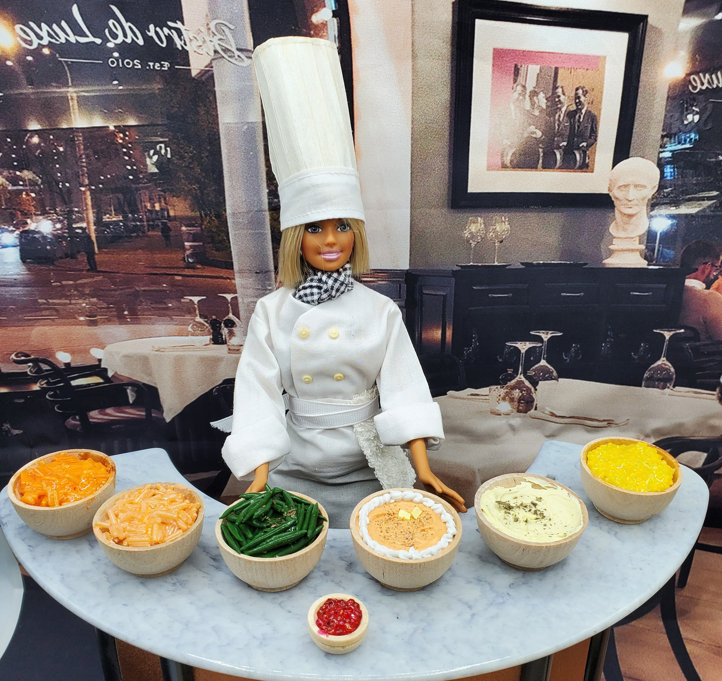 Chef Gina's handmade doll food sweet potatoes and assorted sides displayed with chef doll on table