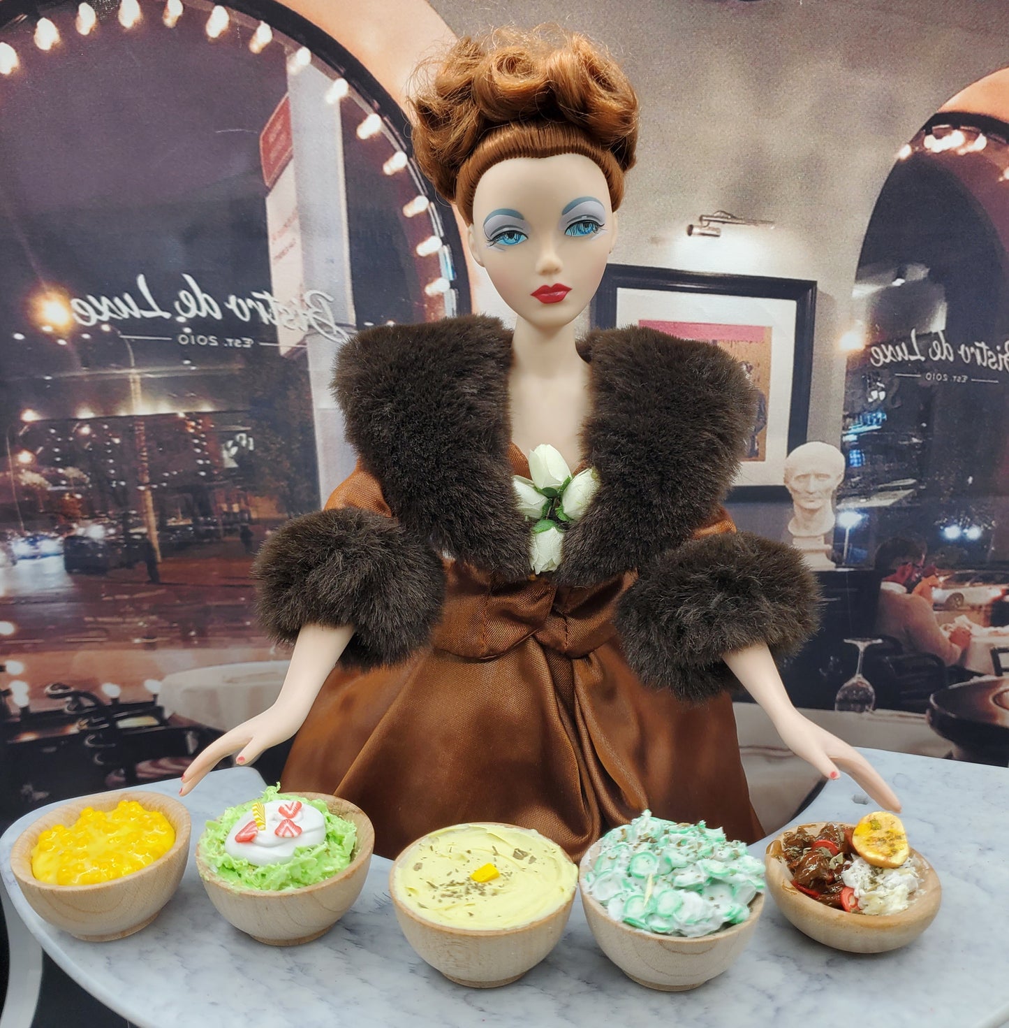 Mini pistachio dessert for dolls and other miniature food bowls displayed in front of a vintage doll in a brown fur coat