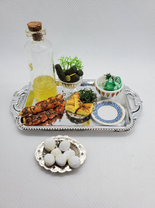 Chef Gina's miniature Greek food set featuring skewers, olives, and a bottle of olive oil