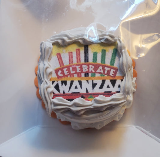 Chef Gina's miniature Kwanzaa cake for dolls decorated with colorful Kwanzaa symbols and white frosting