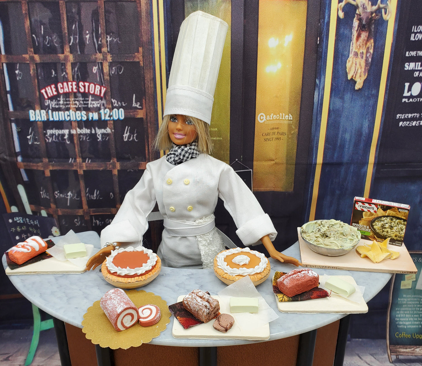 Chef Gina's miniature orange cream bread and assorted mini desserts displayed with a chef doll on a round table