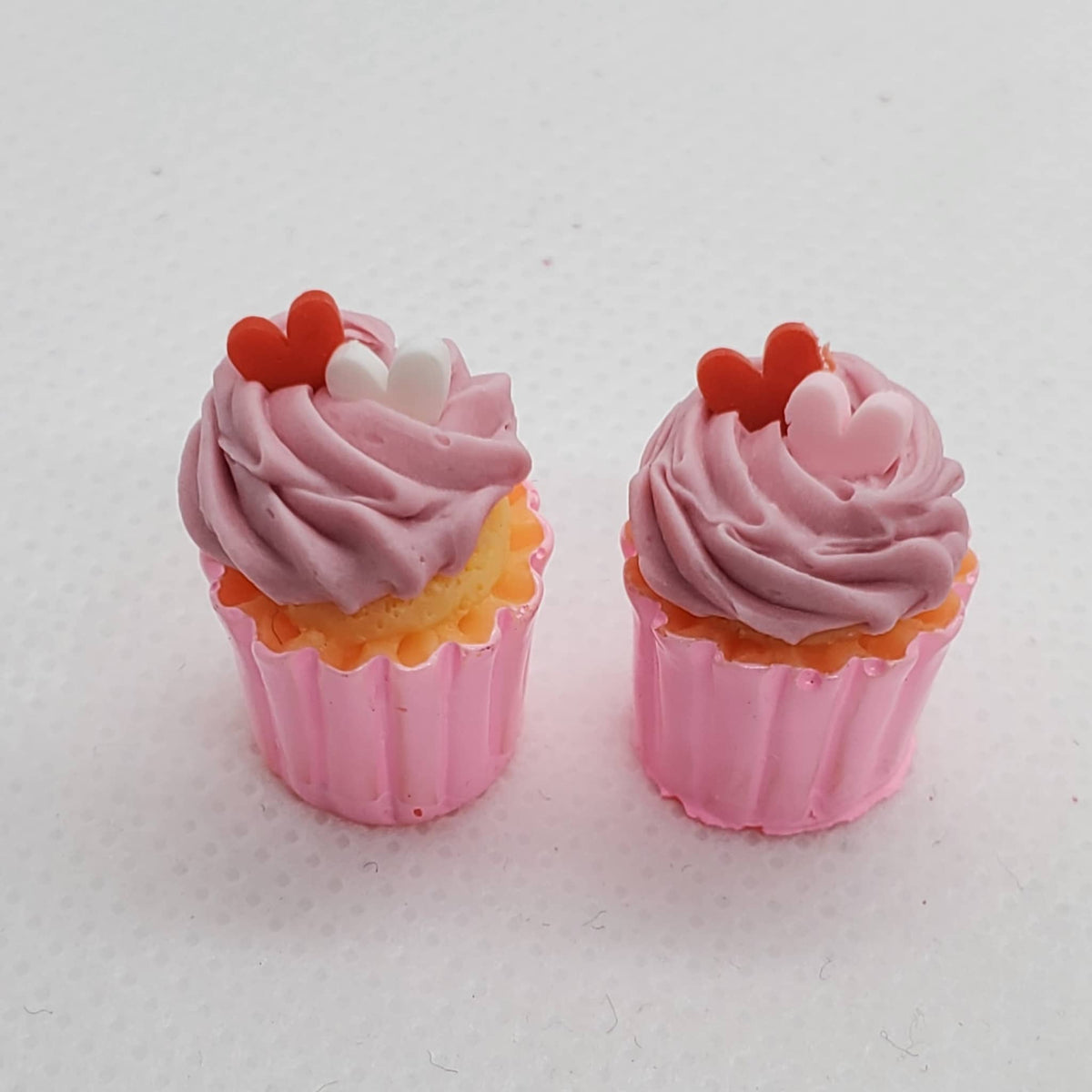 Chef Gina's miniature Valentine's cupcakes with pink frosting and heart-shaped decorations in pink liners
