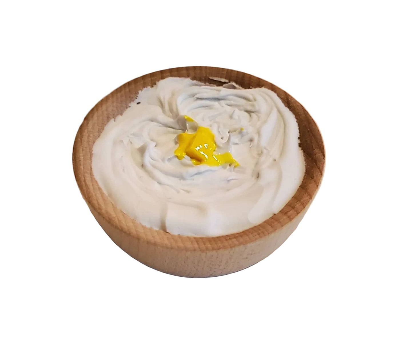 Wooden bowl with white cream and a yellow star on a beige background