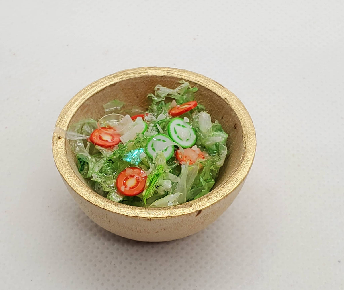Salad for Fashion Dolls in a small gold bowl with miniature lettuce, cucumber, and tomato slices