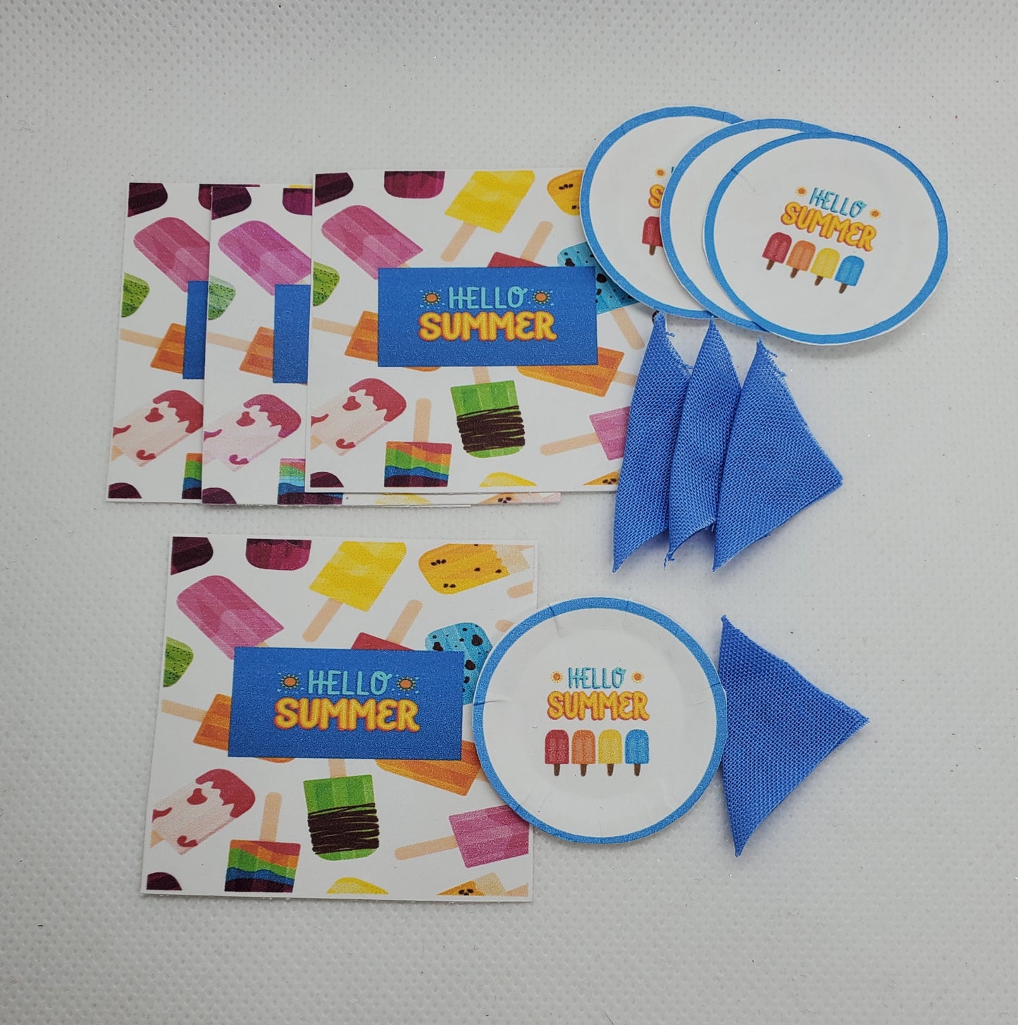 Summer doll party supplies featuring colorful ice cream designs and blue fabric accessories