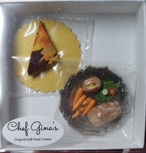 Miniature Cornish game hen set with carrots and garnish in a decorative plate by Chef Gina's