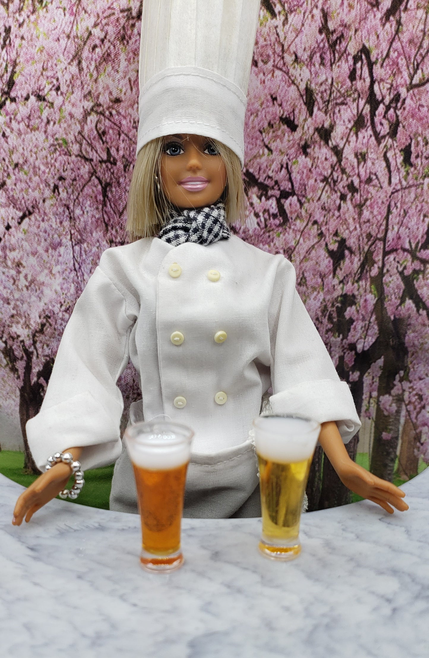 Chef doll with miniature beer mugs for dolls displayed on a marble countertop