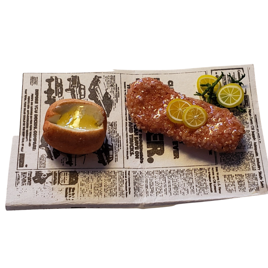 Miniature fried fish for dolls served on newspaper with lemon and a roll for realistic pretend play