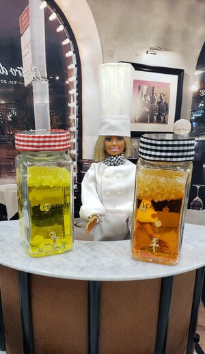 Miniature ice tea dispenser with two jars of colorful iced tea and a chef figure for decorative display