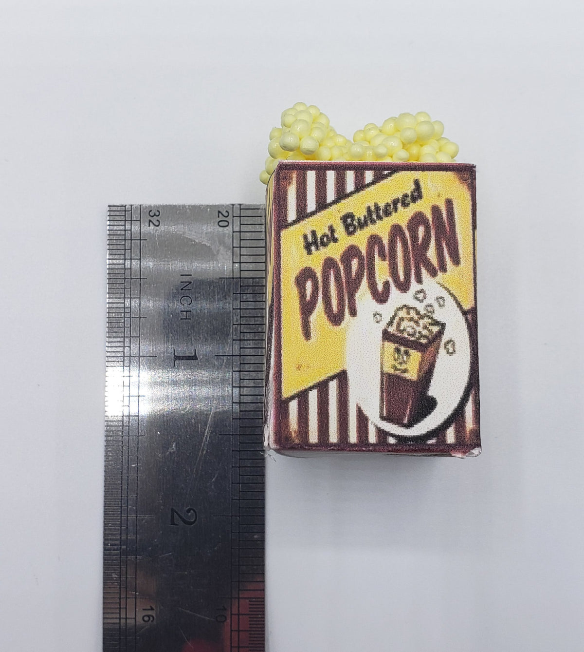 Chef Gina's miniature popcorn tub carnival food prop with ruler showing small size