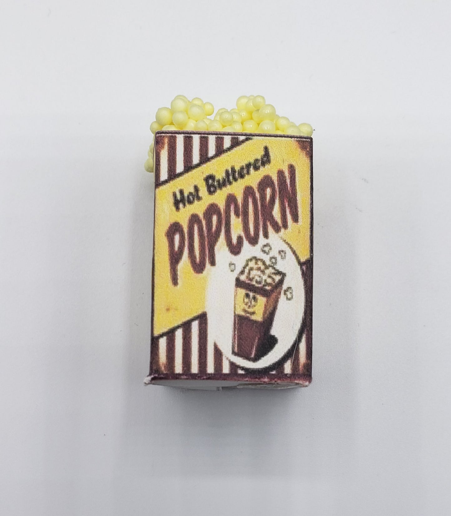 Chef Gina's miniature popcorn tub with hot buttered popcorn design and yellow popcorn kernels