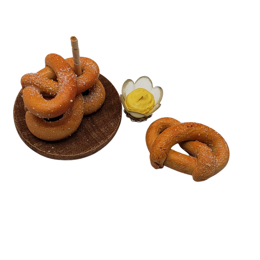 Chef Gina's® Mini Food miniature pretzel tower with three pretzels and a dipping cup of mustard