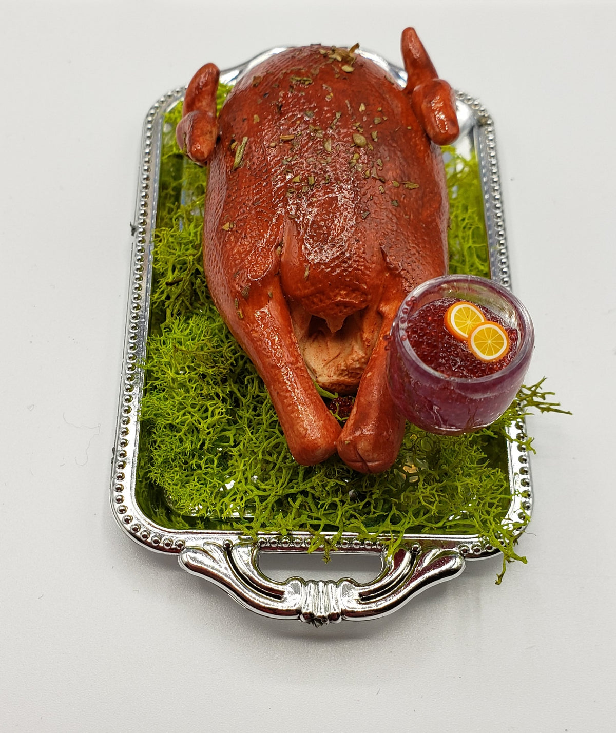 Miniature turkey platter for dolls with roasted turkey served on silver tray with green garnish and drink