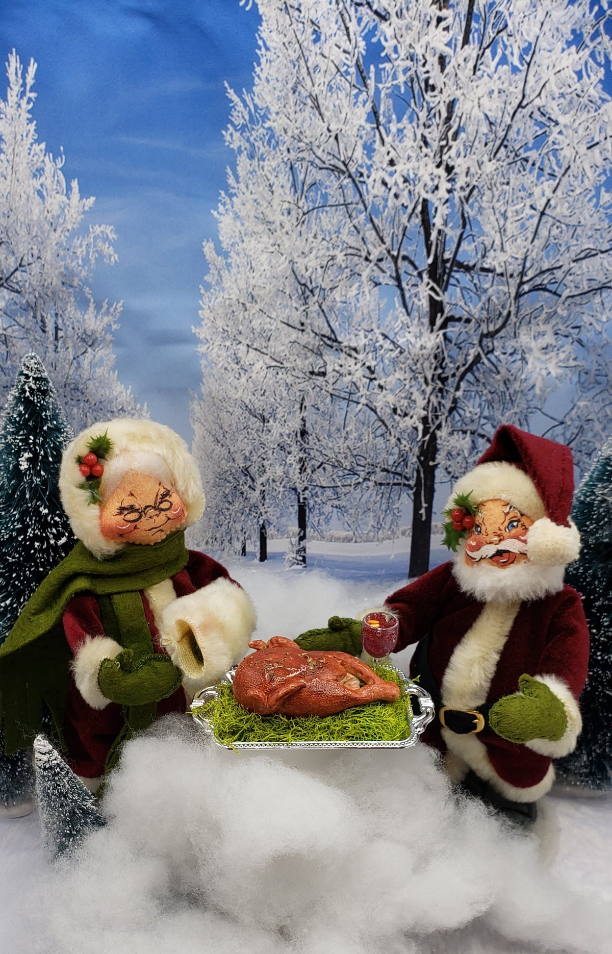 Miniature turkey platter for dolls displayed by two holiday dolls in winter snowy forest scene
