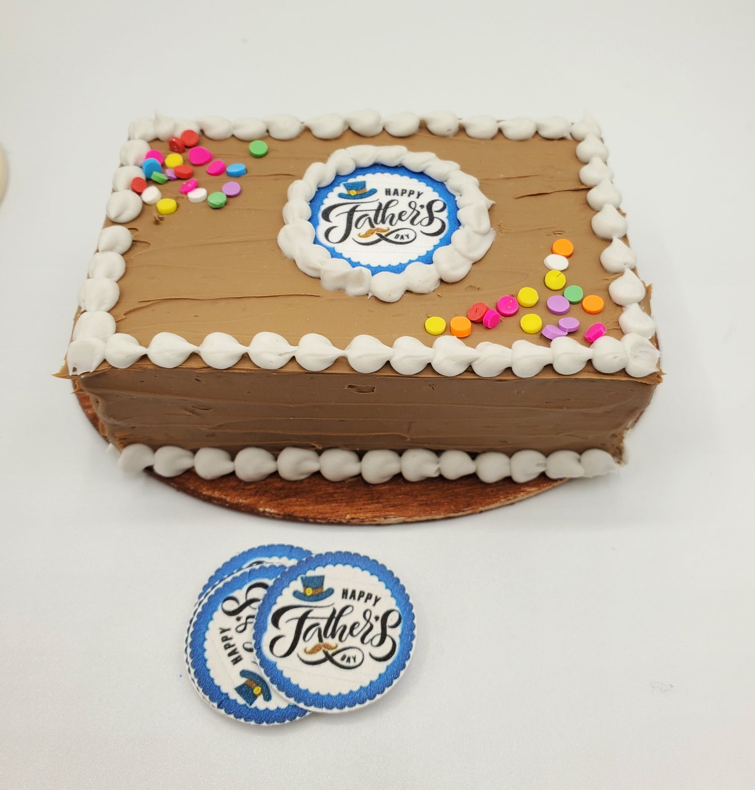 1:4 scale Father's Day chocolate cake with colorful decorations and a festive logo
