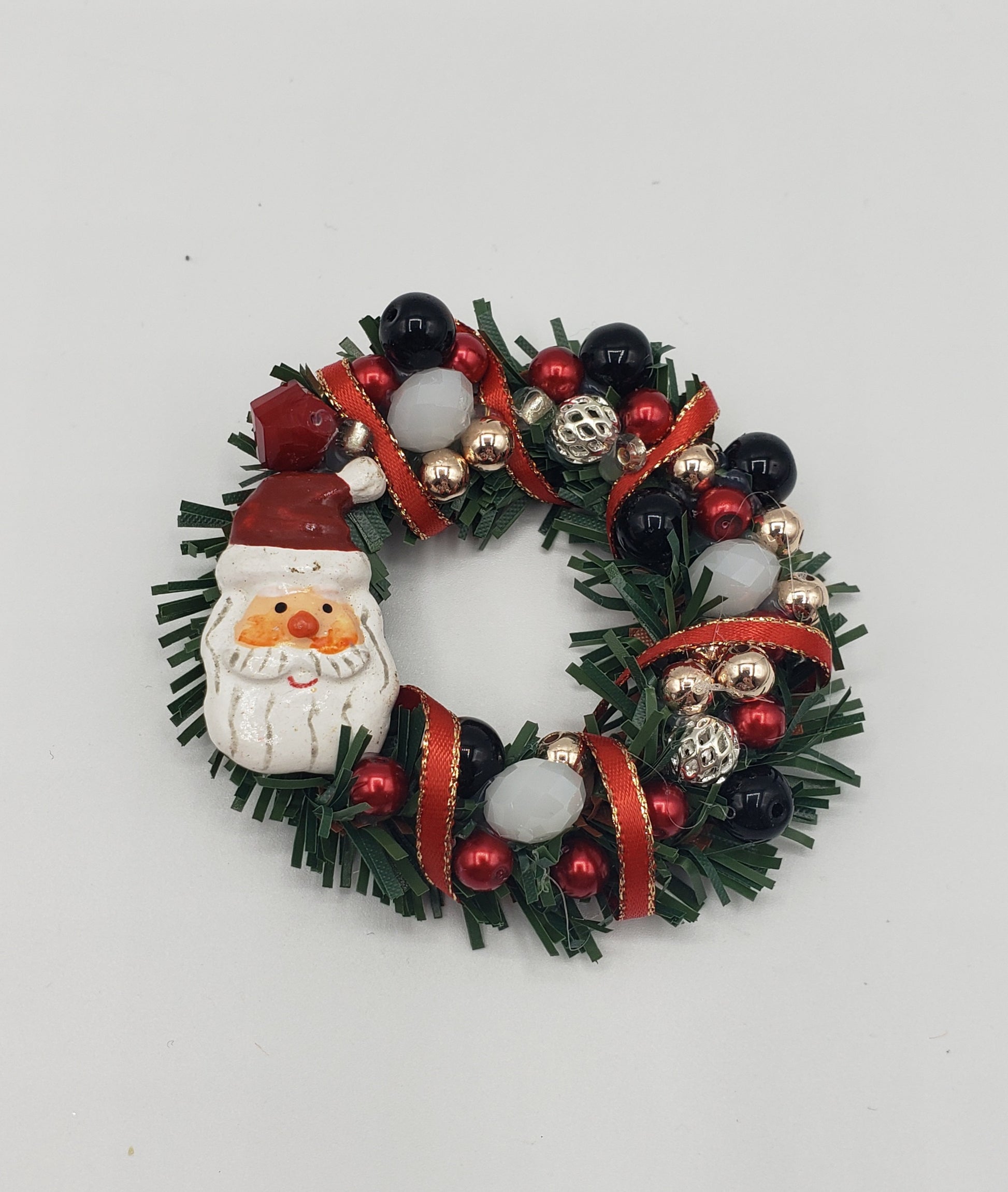 santa Wreath with red, white , black, silver and gold beads