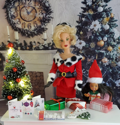 Barbie doll in a Santa outfit with Christmas decorations and tree in the background.