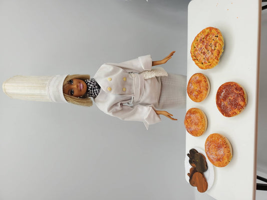 Chef Gina's Mini Food Doll with Assorted Pastries on White Table for Playtime Cooking Fun