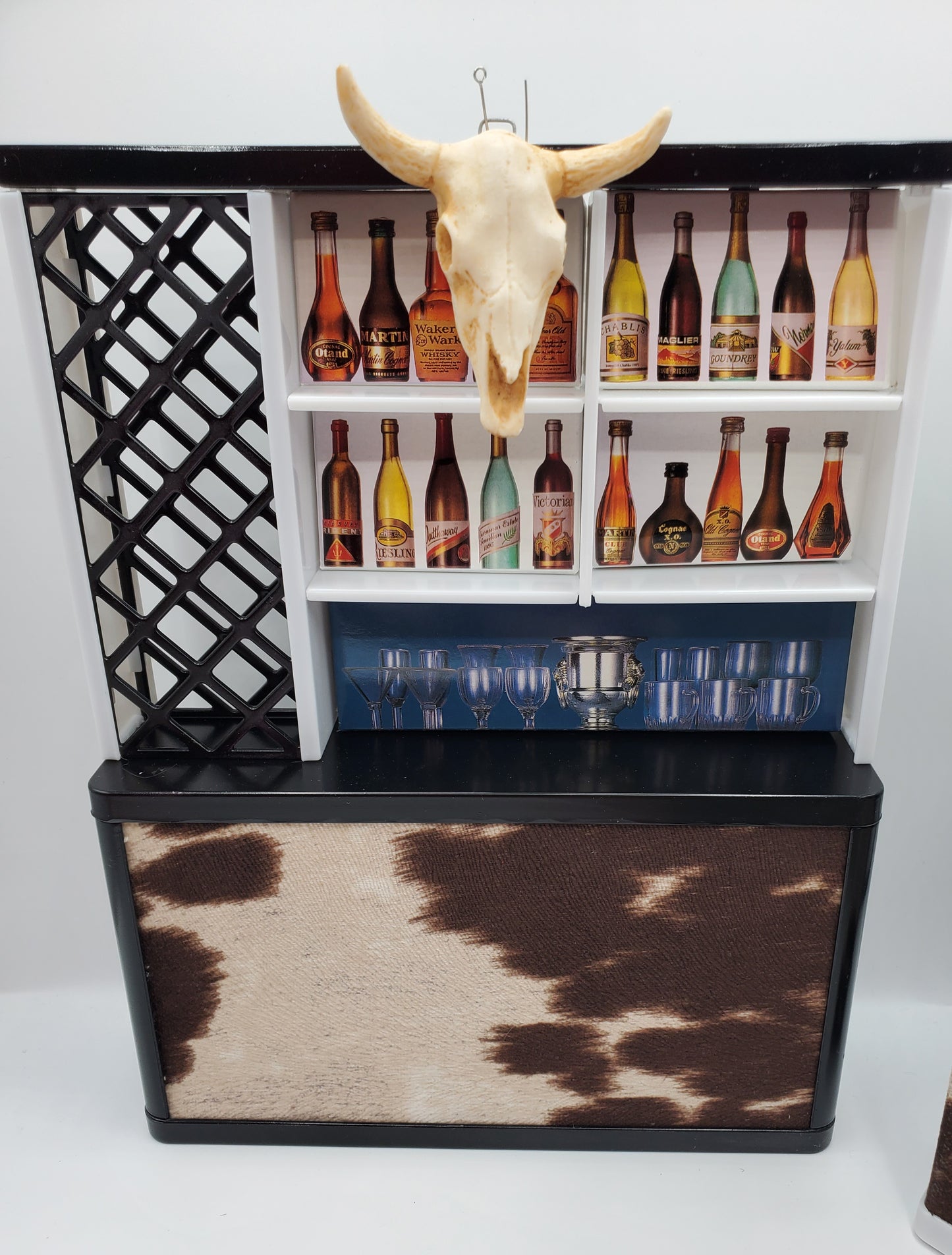 Country western bar set for dolls with mini bottles, glasses, and a decorative bull skull on top