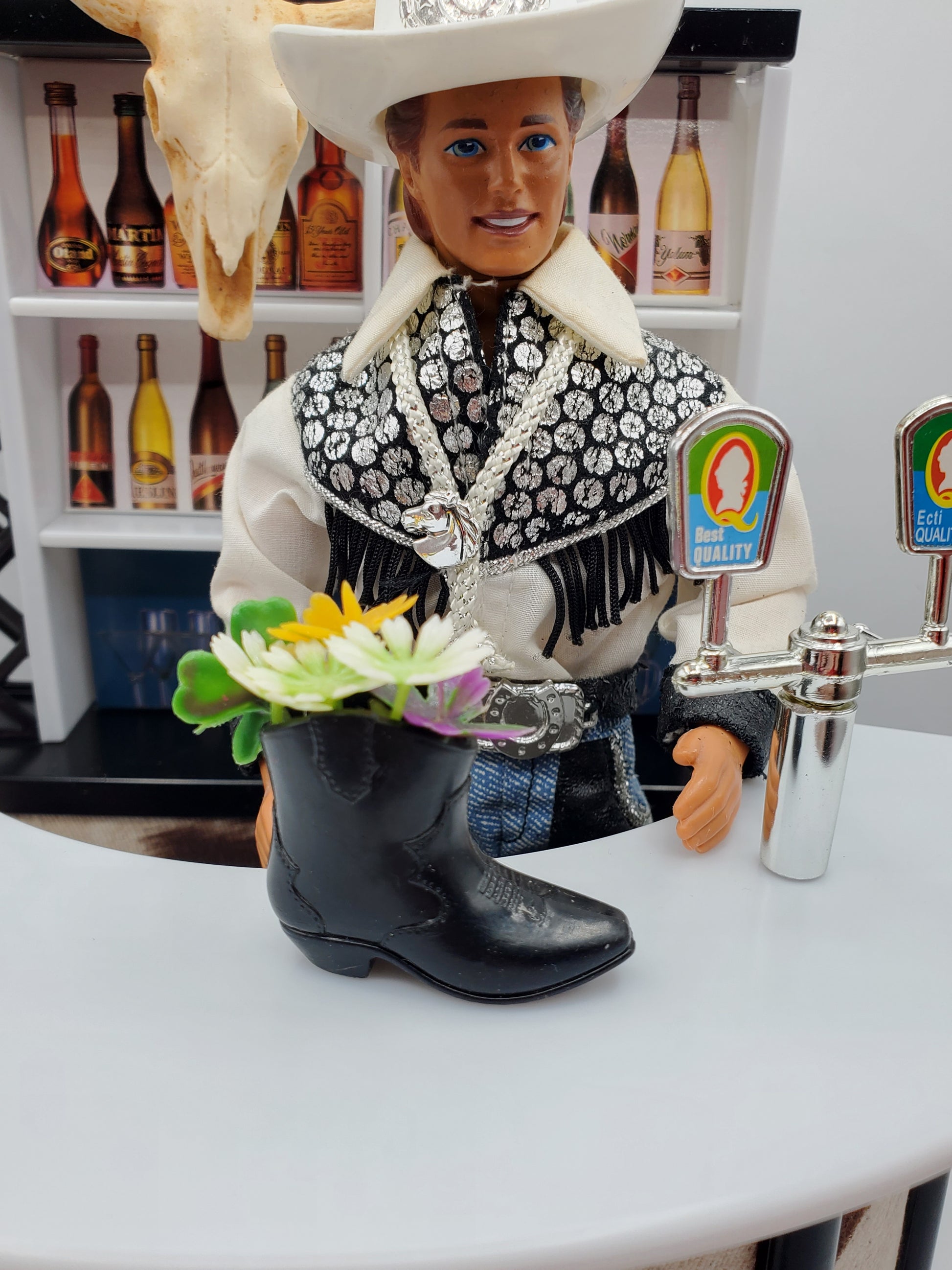 Cowboy boot bouquet for Fashion dolls with colorful flowers in black boot on bar counter
