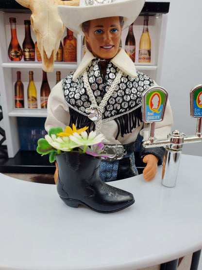 Cowboy boot bouquet for Fashion dolls with colorful flowers in black boot on bar counter
