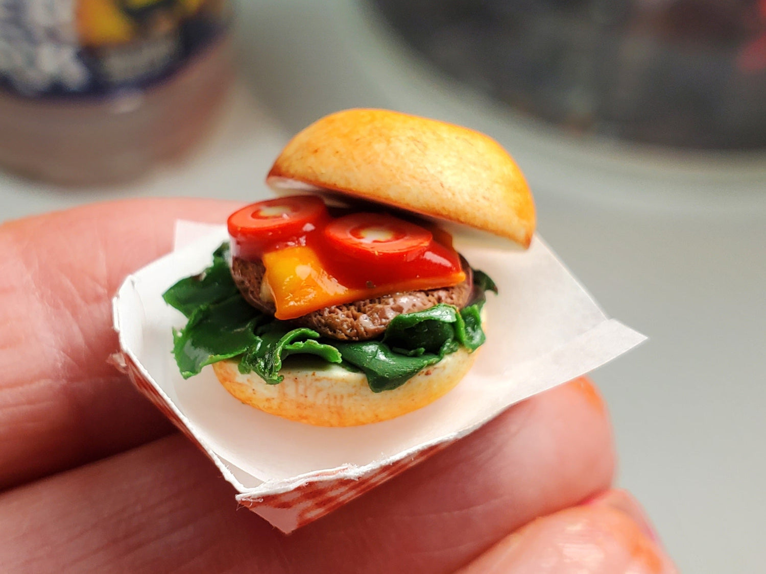 Chef Gina's 1 6 scale cheeseburger for dolls with lettuce tomato and cheese held in hand