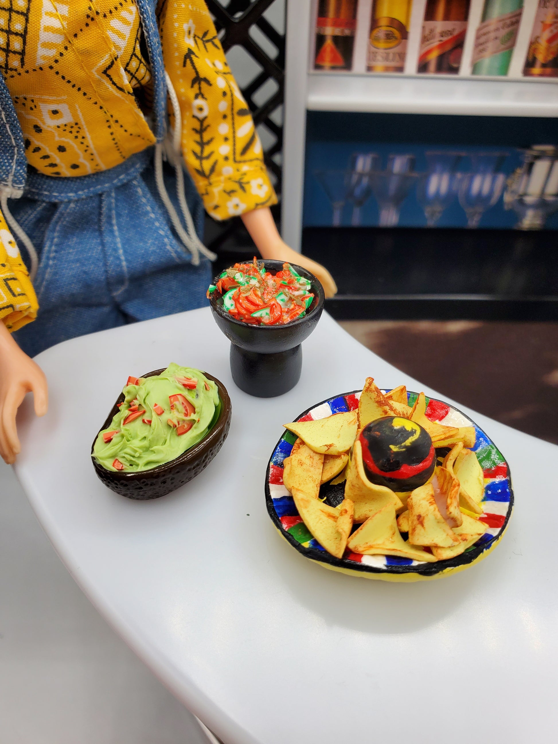 Miniature tortilla chips for dolls with guacamole and salsa in dollhouse kitchen setup
