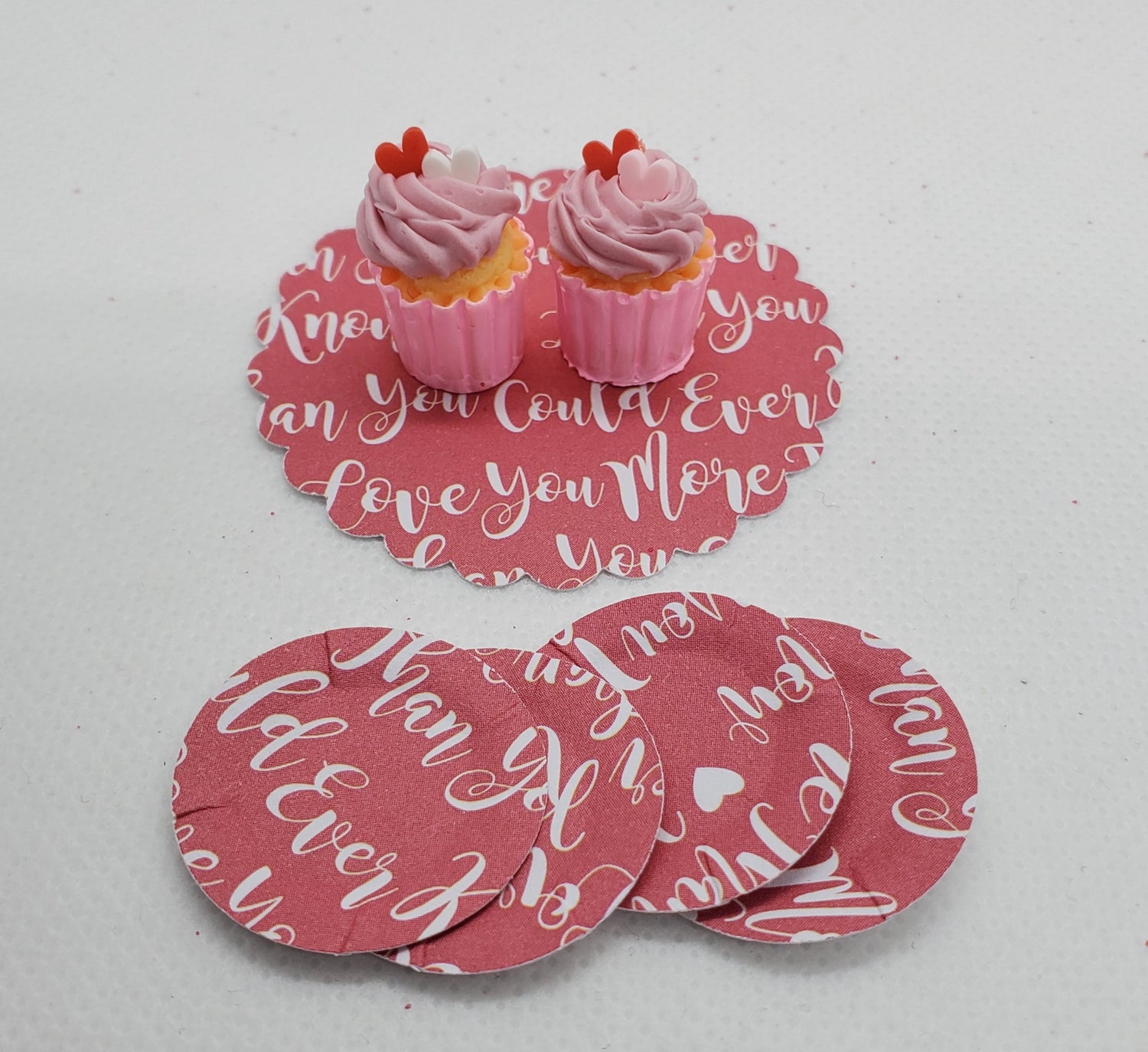 Chef Gina's miniature Valentine's cupcakes with pink frosting and red heart toppers on decorative Valentine's Day cards