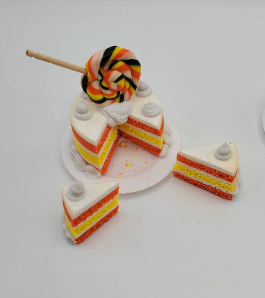 Toy cake set with a slice taken out on a white background