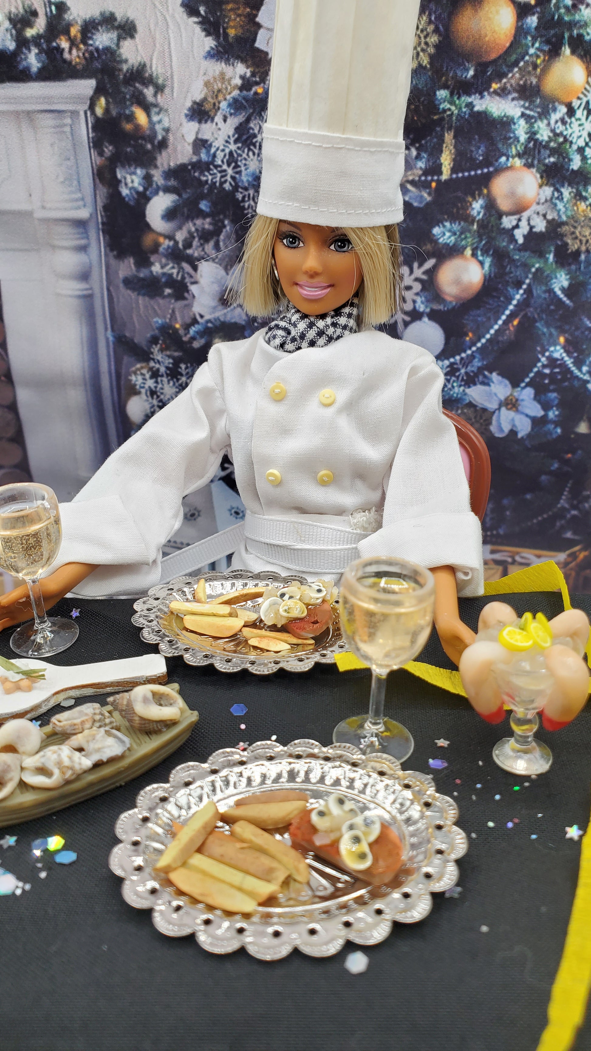 Doll in a chef's outfit with a plate of food on a decorative background
