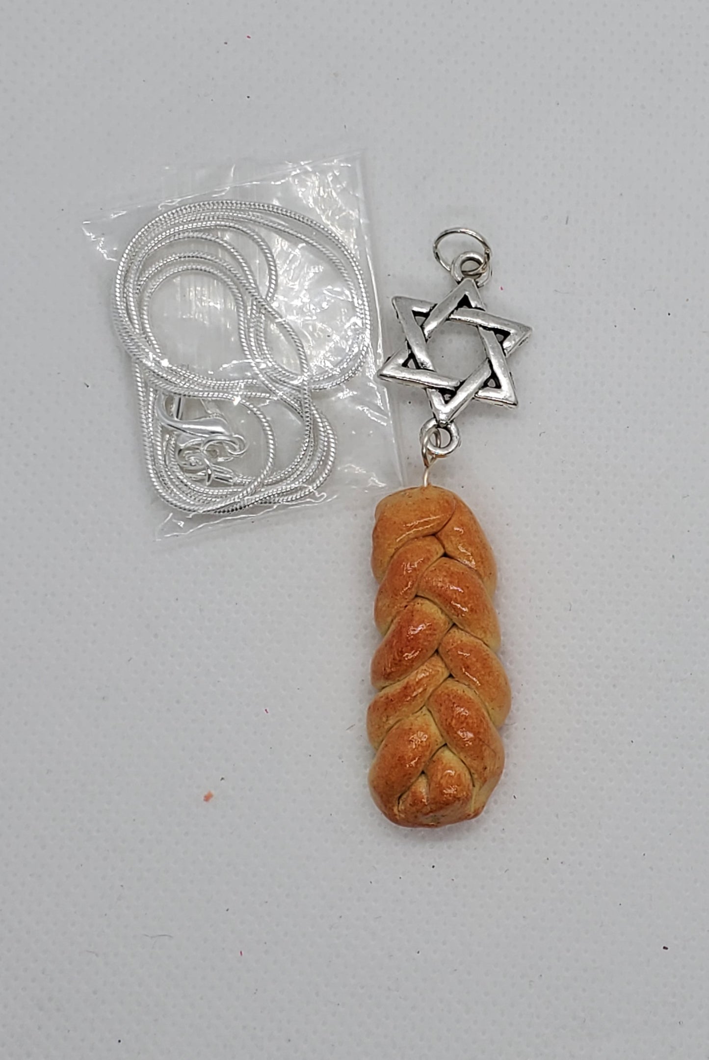 Chef Ginas miniature challah bread jewelry featuring a braided bread charm with Star of David pendant