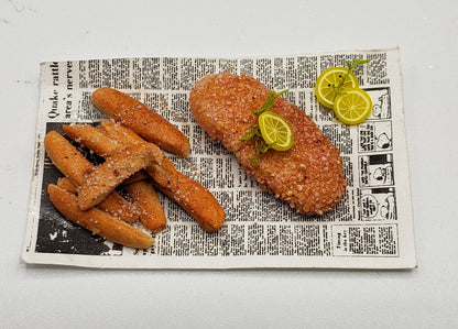 fried fish and fries on a newspaper for barbie