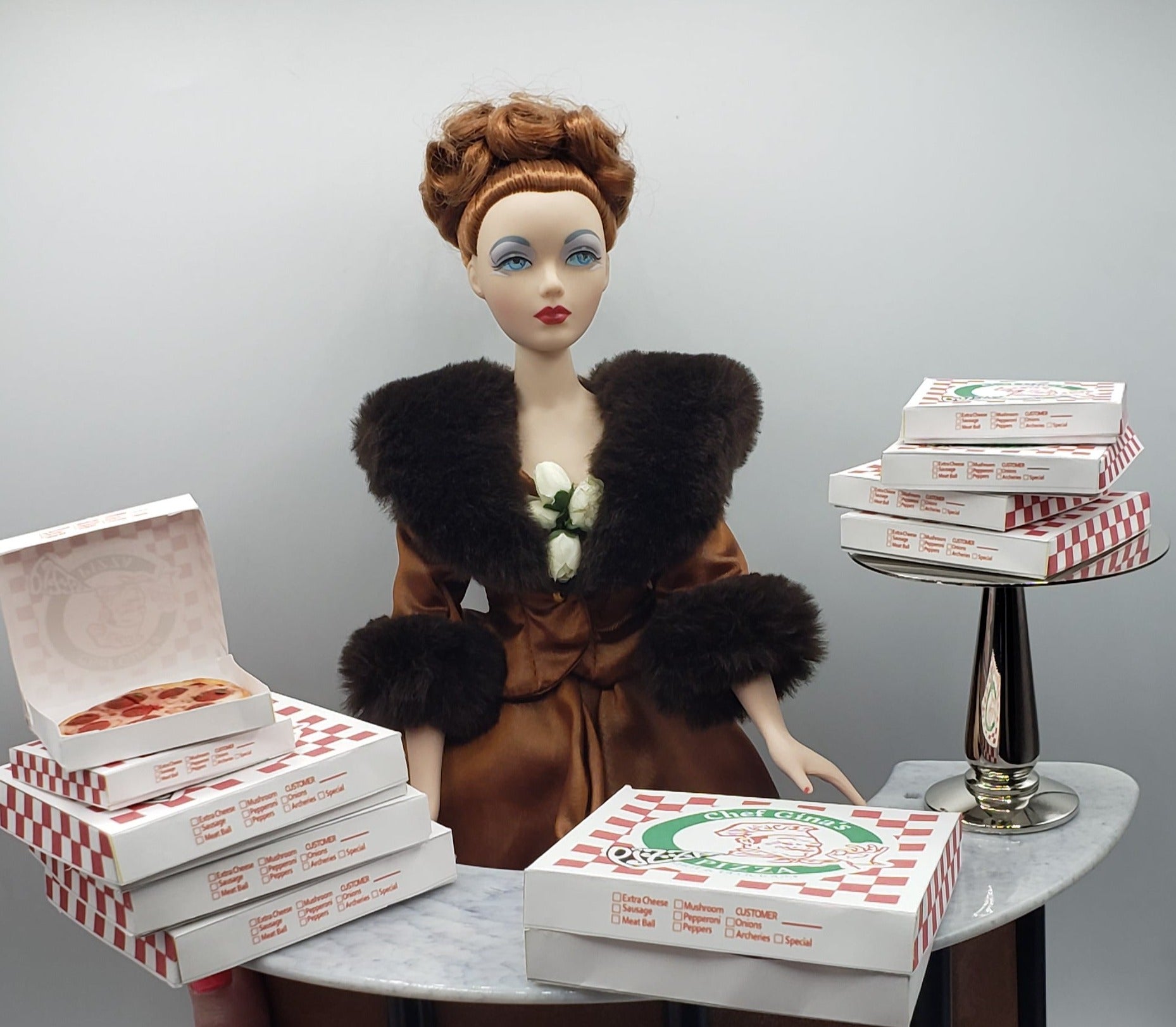 gene doll with pizza boxes